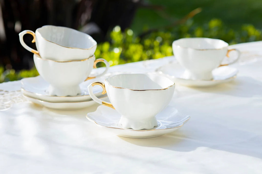 white and gold tea cups