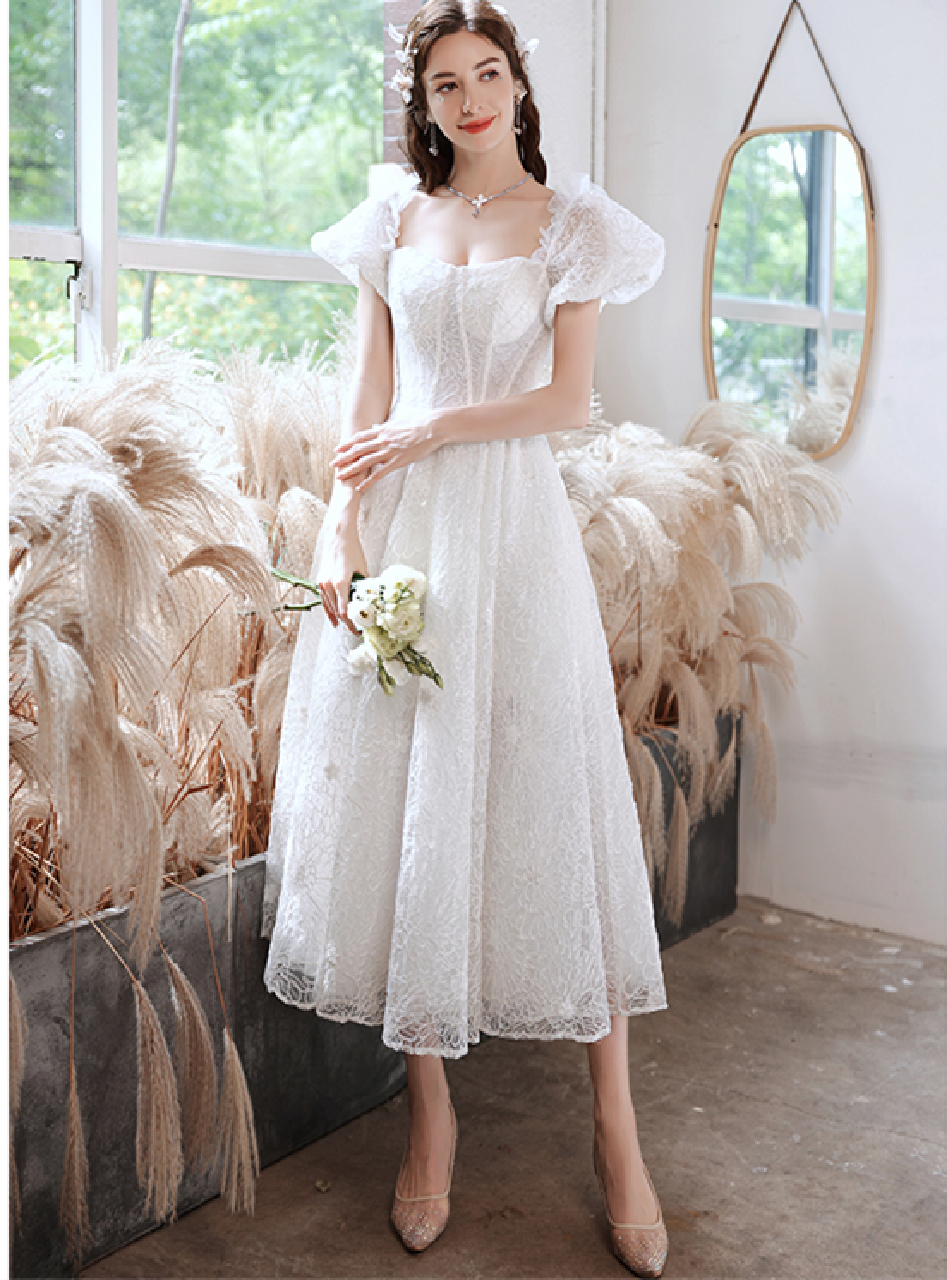 white tea length dress with sleeves