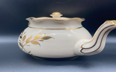 white tea pot with gold trim